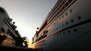 Luxurious cruise ships docked at sunset, showcasing modern design and cruising amenities for vacationers seeking premium travel experiences.